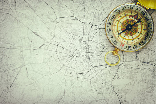 Image of map and old compass. selective focus