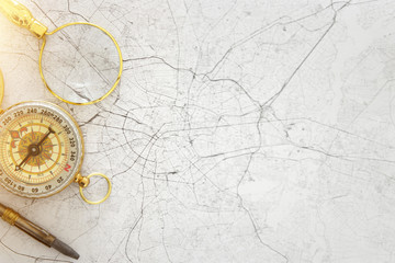 Image of map, magnifying glass and old compass. selective focus
