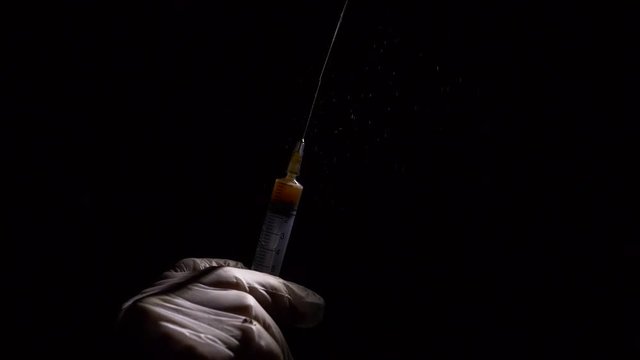 Close-up liquid substance in syringe, drug injection