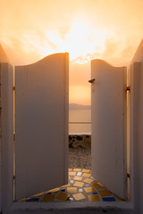 A traditional door yard opened at the bright sunset, Ia, Santorini, Greece. Honeymoon summer aegean cycladic background, serenity, tranquility.