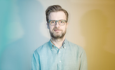 Obraz premium Colorful portrait of caucasian bearded man in glasses