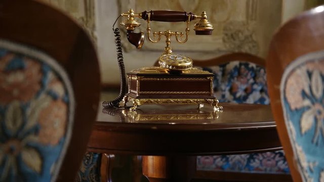 Luxury interior &ndash; vintage telephone on table and armchairs