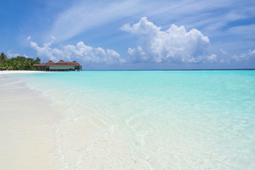 Tropical sand beach and blue sky with white clouds