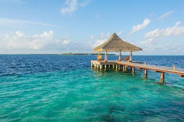 Wooden pier on a tropical beach in the Maldives
