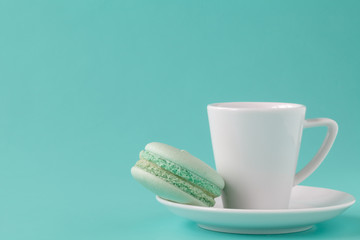 Green macaroon with coffee cup