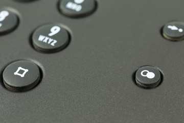 redial push button of a black telephone