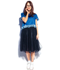 Portrait of beautiful smart smiling hipster brunette woman model in casual stylish blue jeans clothes and glasses isolated on white.Giving a kiss, full length