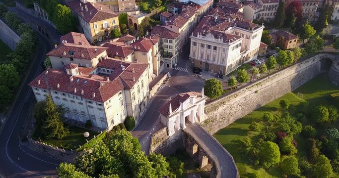 4K Drone aerial view of Bergamo - Old city (Citt&agrave; Alta). One of the beautiful city in Italy. Landscape on the old gate named Porta San Giacomo and historical buildings during a wonderful blu day