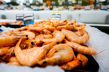 Raw crevettes at market stall counter