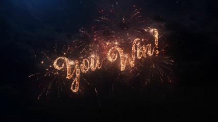 You Win greeting text with particles and sparks on black night sky with colored slow motion fireworks on background, beautiful typography magic design.