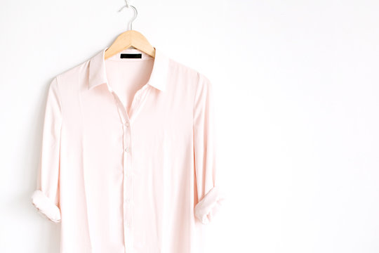 Front View Of Beauty Trendy Pink Female Blouse On Hanger Near White Background. Fashion Concept.