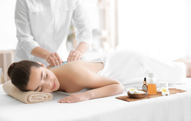 Obraz na płótnie Canvas Beautiful young woman receiving scrub massage in spa salon