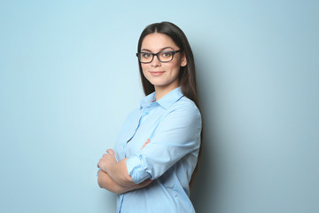 Young beautiful woman on light background