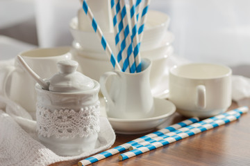 Set of white empty tableware with striped tubules