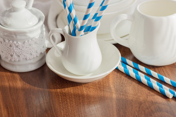 Set of white empty tableware with striped tubules