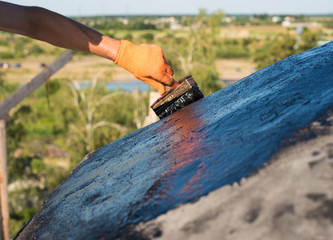 worker making waterproofing.