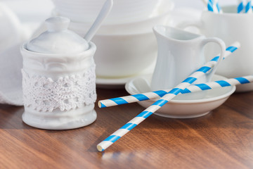 Set of white empty tableware with striped tubules