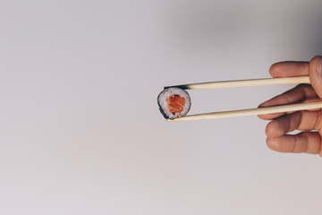 Chopsticks and sushi composition