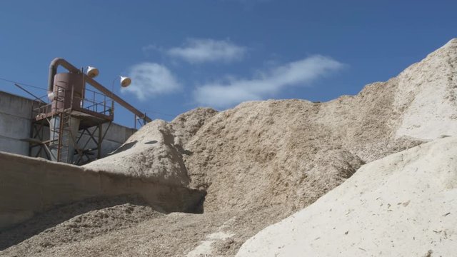 A tractor is throwing down sawdust