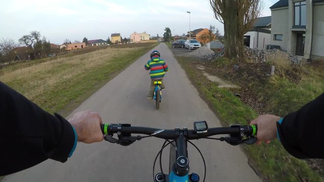 Cute little boy riding a bike.	
Boy riding a bike along the cycle path. Stabilized video.
