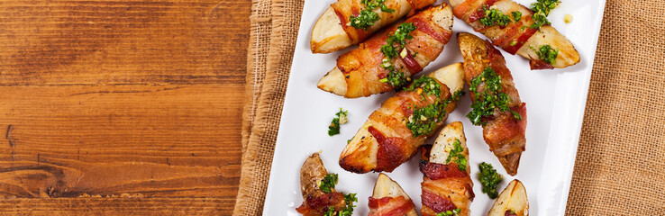 Bacon Wrapped Potatoes with Parsley Garlic Pesto Sauce. Selective focus.