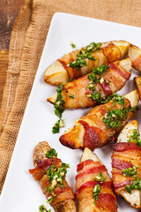 Bacon Wrapped Potatoes with Parsley Garlic Pesto Sauce. Selective focus.