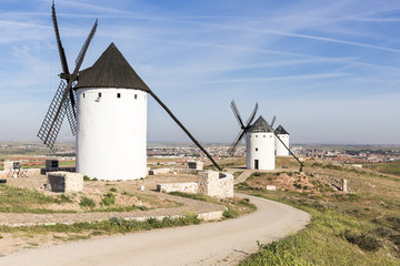 white windmills and a view of Alcazar de San Juan town, province of Ciudad Real, Castilla-La Mancha, Spain