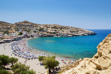 Naklejka na ściany i meble Blue lagoon with sandy beach of Matala town on Crete island, Greece