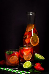 Strawberry Lime Lemonade Summer Drink on Black Background. Selective focus.