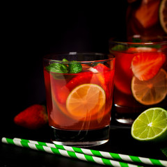 Strawberry Lime Lemonade Summer Drink on Black Background. Selective focus.