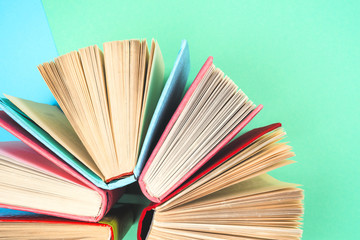Top view of bright colorful hardback books in a circle.