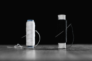 two coils with white and black threads