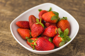 Freshly Handpicked Strawberries in a Bowl on Wooden Table