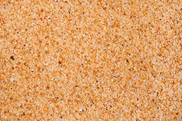 Macro texture of beach sand. The background of yellow sand.