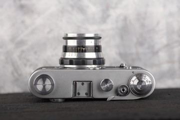 The old rangefinder camera on a cement background.