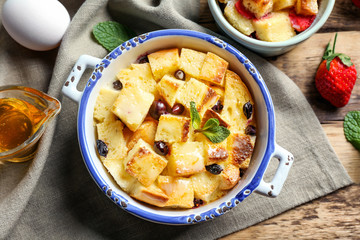 Delicious bread pudding with berries in bowl on napkin