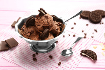 Metal bowl with delicious chocolate ice cream on pink wooden table