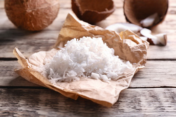 Coconut flakes on wooden background