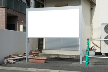 Large blank billboard on a street wall, banners with room to add your own text