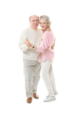 Happy senior couple dancing on white background