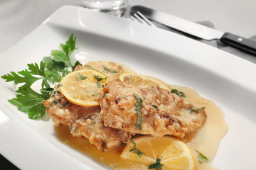 Tasty Italian chicken piccata with lemon on plate