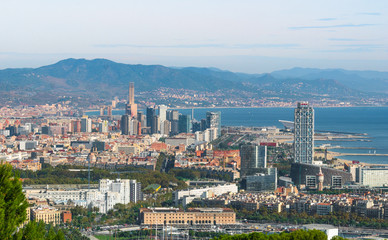 Beautiful Blue commerce.  Coastline of Spain in seaside Barcelona.  Modern city scape & coastline as seen from high level, cable car over the city. 