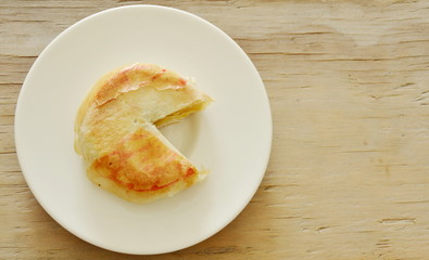 Chinese cake filled mushed bean and salty egg cut for pieces on plate