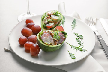 Plate with chicken salad in boats from avocado