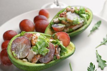Plate with chicken salad in boats from avocado