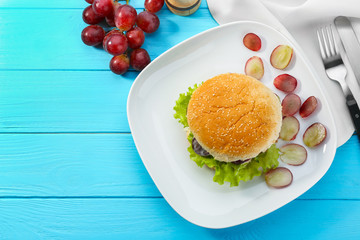 Plate with chicken salad in burger bun on  table