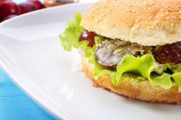Plate with chicken salad in burger bun, closeup