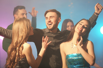 Friends having fun at party in night club
