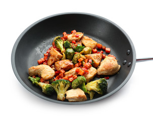 Chicken stir fry with vegetables in pan on white background