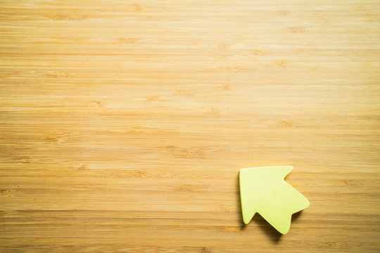 business concept. Arrow direction shape showing the increase of decrease of any subject on the wood texture background